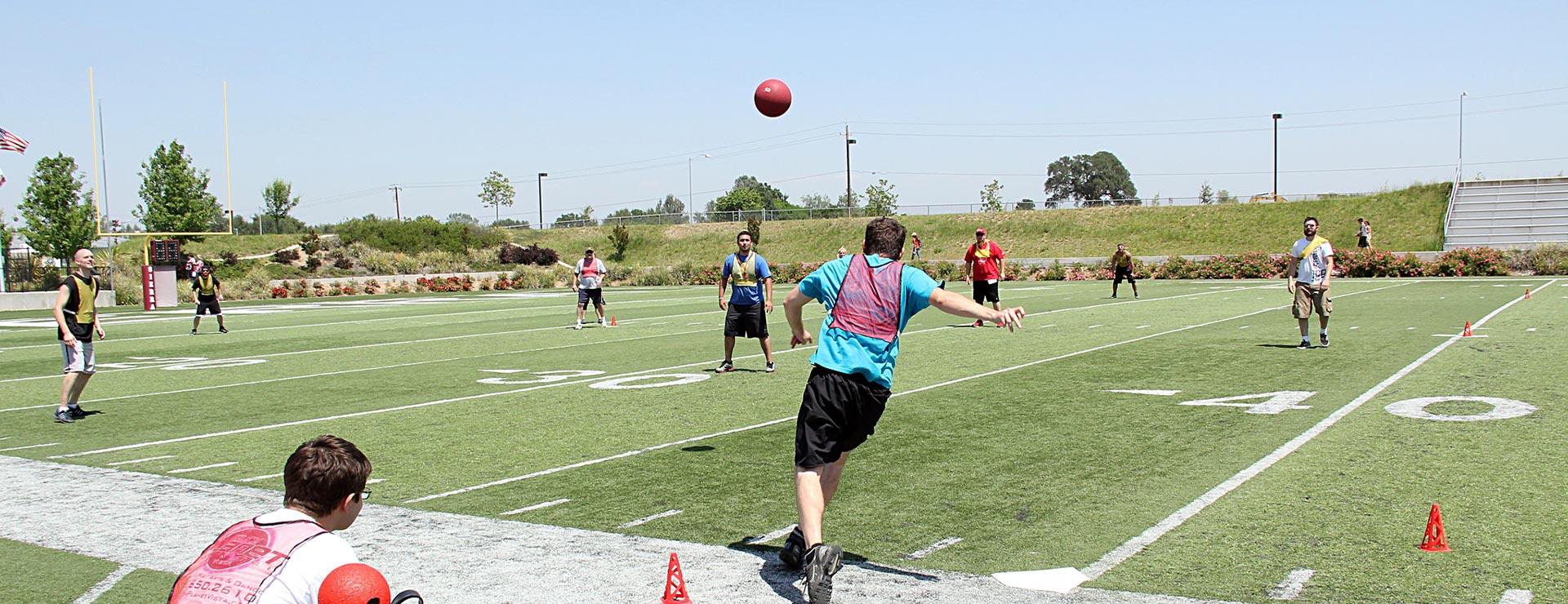 Male students playing soccer on field