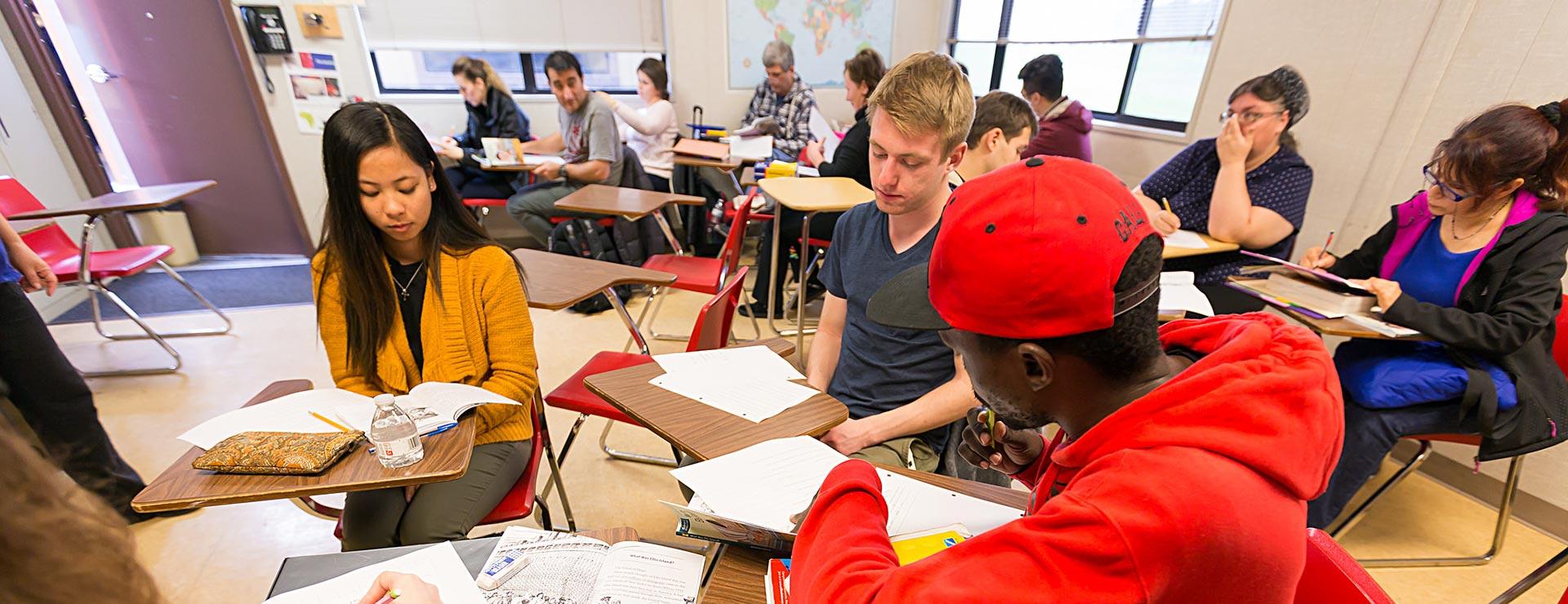 Students meeting in small groups to work on classroom group assignment