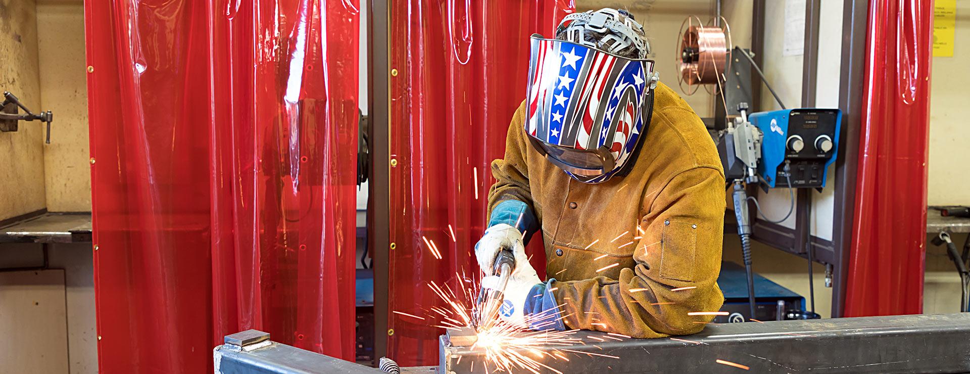 Welding student operating welding equipment