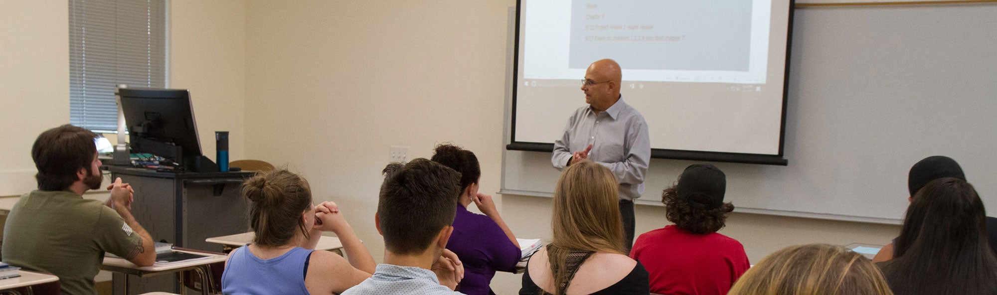 Business instructor leading classroom discussion