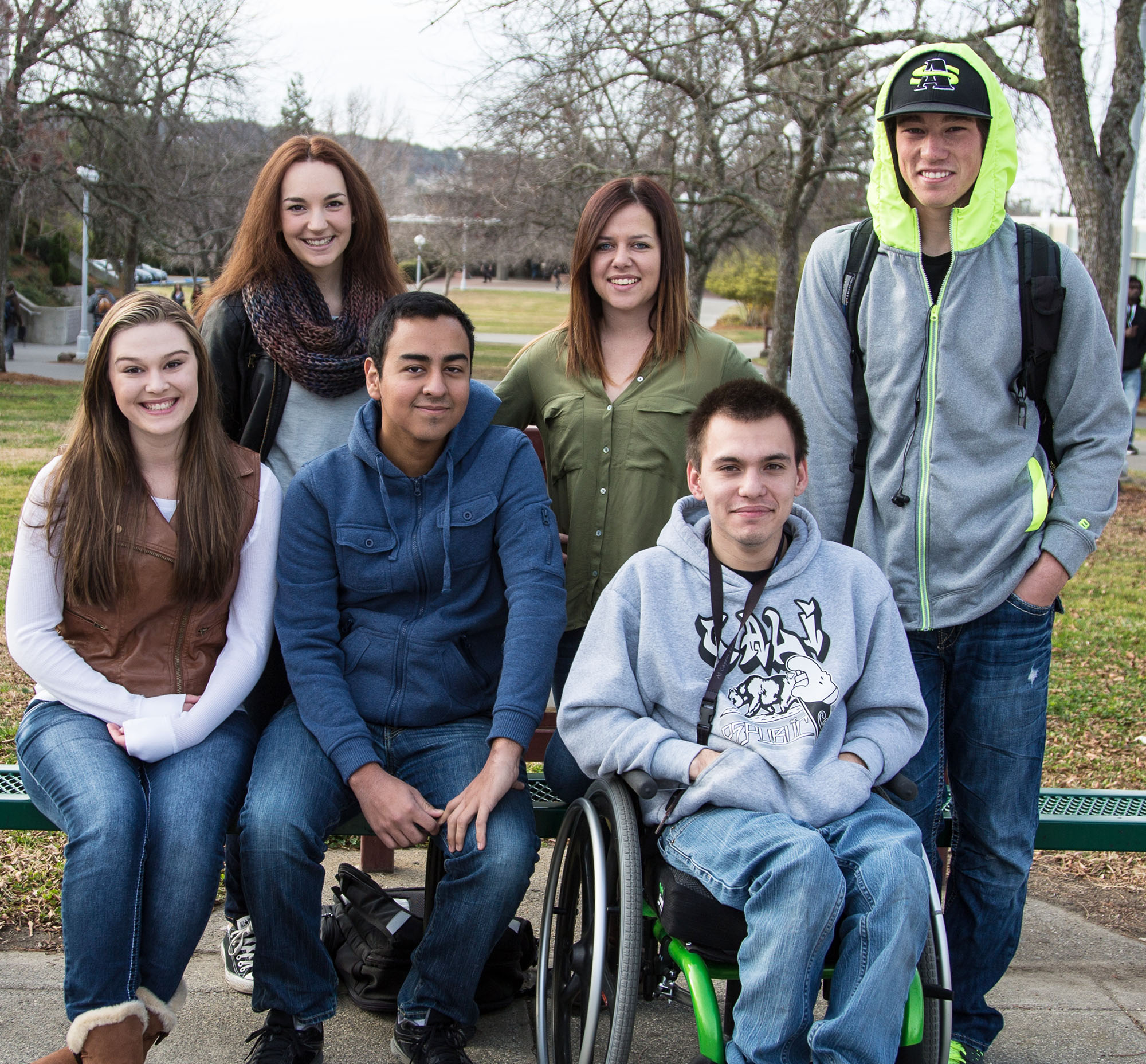 Three female students, two male students of color, one male student in a wheelchair