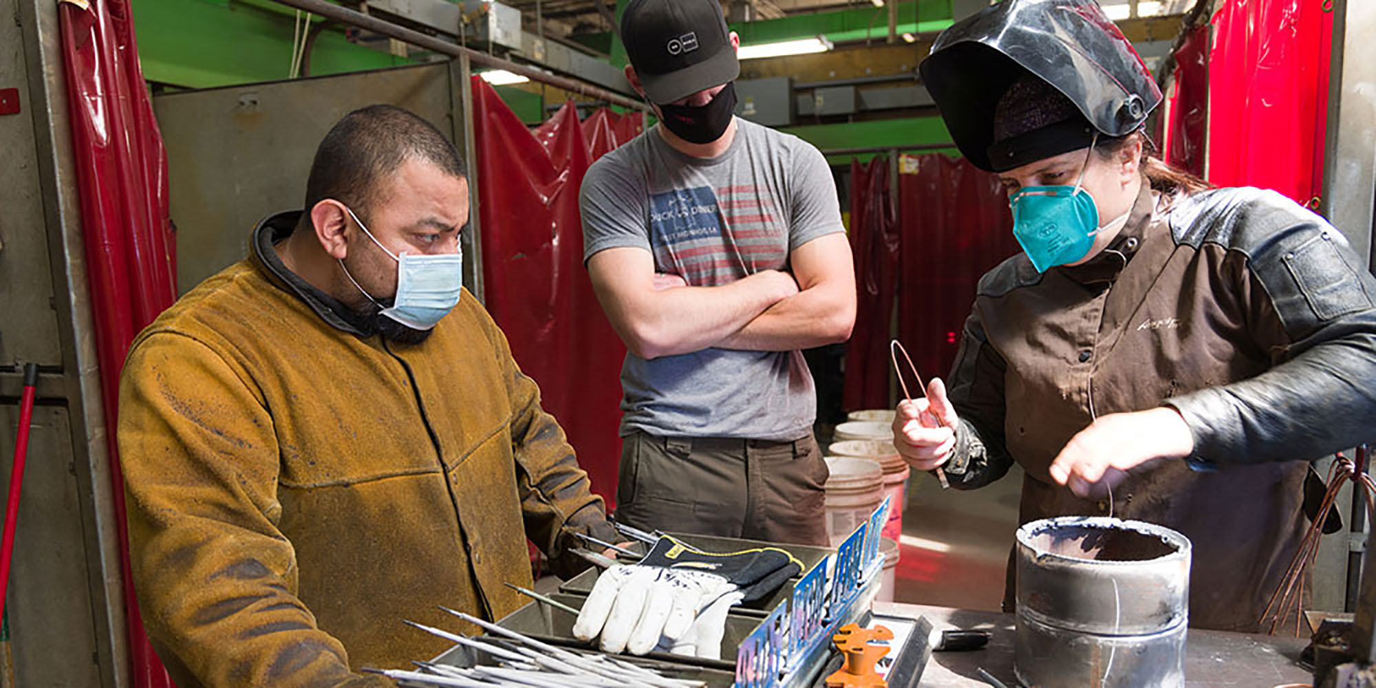 Three welding students working on a project