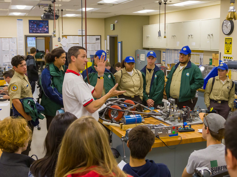 Mechatronics instructor leads demonstration in classroom as students look on