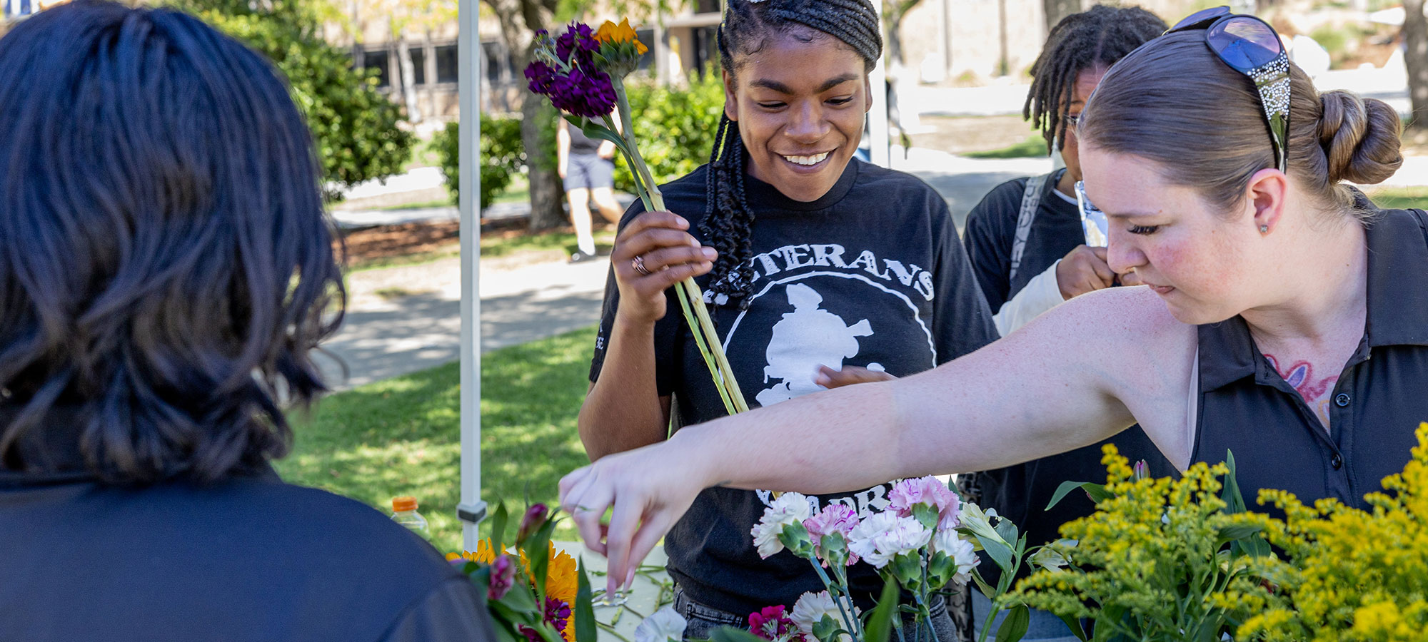 Students making flower arrangements to give to themselves or others