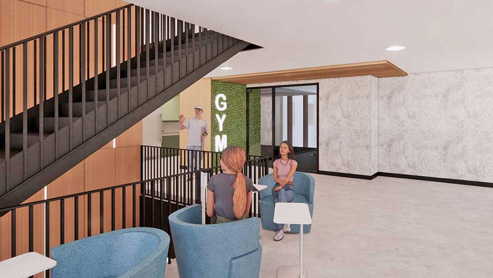 Rendering of students chatting and studying in atrium on second floor near indoor gym in student housing